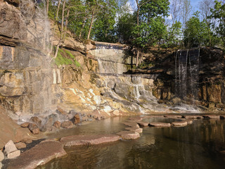beautiful landscape of a waterfall in granite stones in Sofievka park
