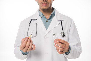 Cropped view of doctor holding syringe and jar with vaccine isolated on white