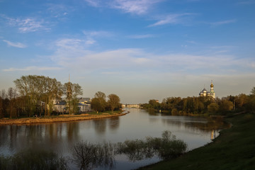 Fototapeta na wymiar Vologda. Beautiful spring evening on the Vologda river Bank. Church Of The Meeting Of The Lord. 18th century; St. Sophia Cathedral