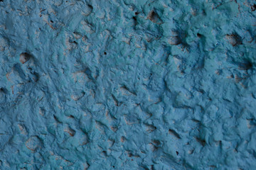 Blurred abstract blue background. Blue tuberous cement surface. Beautiful abstract background. Texture of painted stone wall. Textured blue background. Horizontal. Design concept.