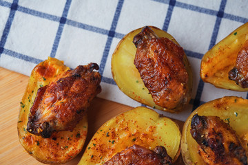 Baked chicken wings on potatoes