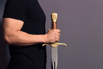 Young Athletic Man Holding His Sword