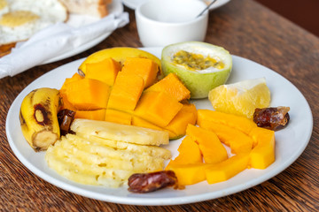 Tropical fruits on a breakfast plate, close up