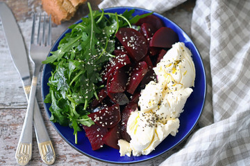 Selective focus. Delicious salad with beets, arugula and mascarpone cheese. Keto salad. Keto diet.