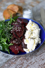 Selective focus. Delicious salad with beets, arugula and mascarpone cheese. Keto salad. Keto diet.