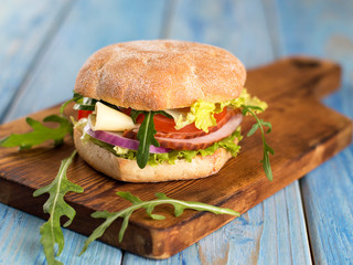 ham and greens cheese sandwich on the kitchen table.