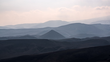 Obraz na płótnie Canvas Mountain terrain in haze landscape