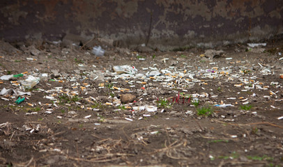 Scattered cigarettes butts on gray concrete floor