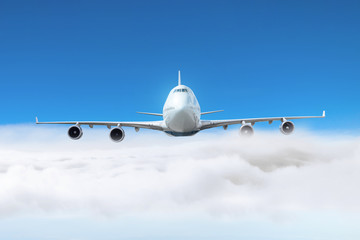 Passenger plane flies on the edge of the overcast day.