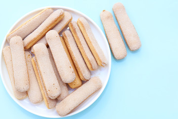 Sweet lady finger biscuits on a plate. Tiramisu biscuits.