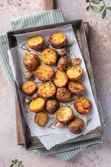Roasted potato with rosemary on a baking sheet