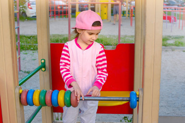 Сhild learns to count. Big scores. Active little girl on playground . Physical development of children, health, classes, free time concept.