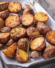 Roasted potato with rosemary on a baking sheet