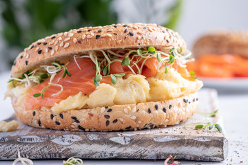 Breakfast sandwich on bagel with salmon and scrumbled egg