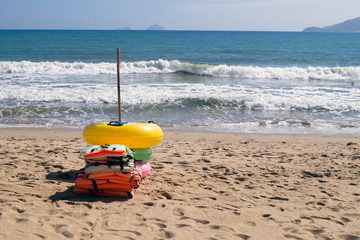  swimming rings and life jackets on the beach