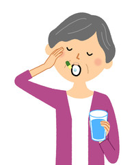 シニア女性　薬を飲む