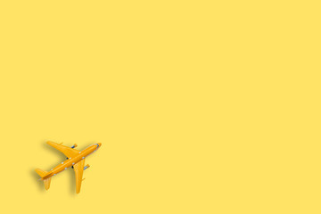 Yellow plane model on yellow background