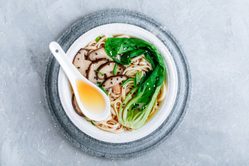 Asian Vegetarian Udon or Ramen noodles soup in bowl with Shiitake mushrooms and Bok Choy