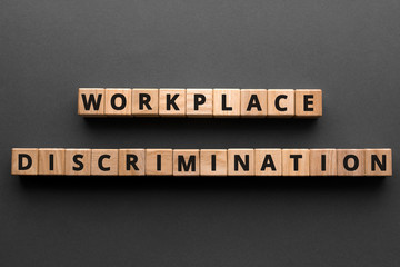 Workplace discrimination - words from wooden blocks with letters, employment discrimination...