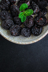 prunes, dried plums (tasty and healthy fruits) menu concept. background. top view. copy space