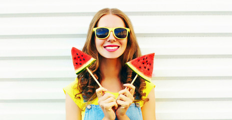 Portrait happy smiling young woman with ice cream shaped watermelon over white background