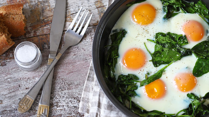 Selective focus. Fried eggs with spinach. Glorious food. Keto diet.