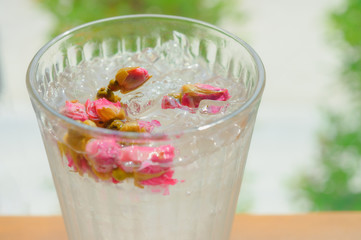 Iced rose tea for Breakfast on Wooden table.