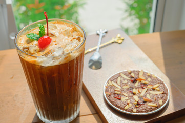 Homemade biscuit brownie with Iced americano coffee for Breakfast on Wooden table.