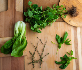 various green herbs on a wooden background