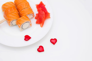Sushi for a Japanese restaurant on a white background. Valentine's day food background top view. Holiday, celebration, food art concept. Copyspace.