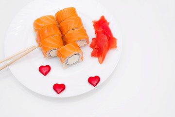 Funny edible sushi Heart, creative idea for a Japanese restaurant on a white background. Valentine's day food background top view . holiday, celebration, food art concept. Copyspace.