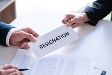 Employee businessman submit or sending resignation document letter to human resource manager or boss, Change of job, unemployment, resign concept.