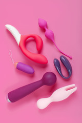 Silicone sex toys on a pink background. Erotic toy for fun. Sex gadget and masturbation device..