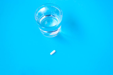 Glass of water, a pill, a medicine for a headache. Virus. Flu. Quarantine. Treatment, cold concept.
