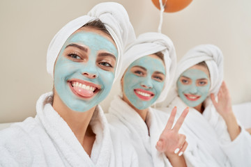 Girls with cosmetic masks taking selfie.