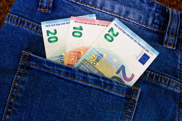 Money in the pocket of jeans. Euro currency