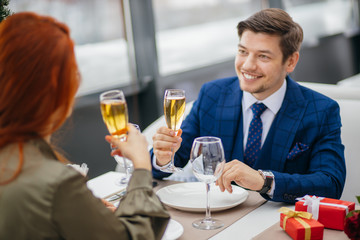 saint valentines day, 8 march, birthday, celebration concept. young and beautiful caucasian lady and handsome guy having dinner,celebrating their anniversary in restaurant. emotions, love