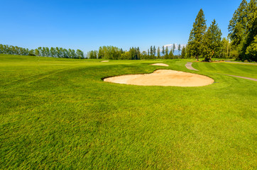 Fototapeta premium Golf course with gorgeous green and sand bunker