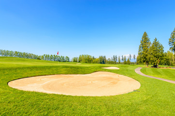 Golf course with gorgeous green and sand bunker