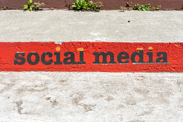 Ladder with social media text on concrete background. Digital marketing concept.