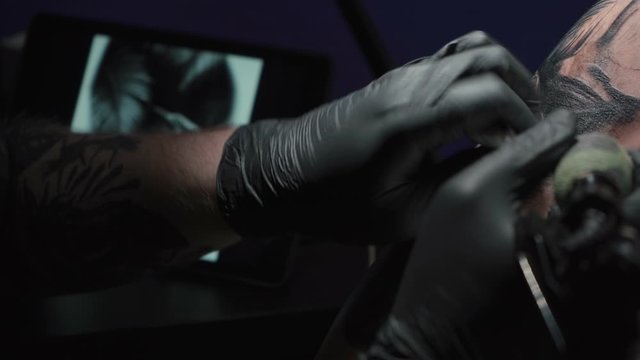 Video of man doing dark tattoo on woman