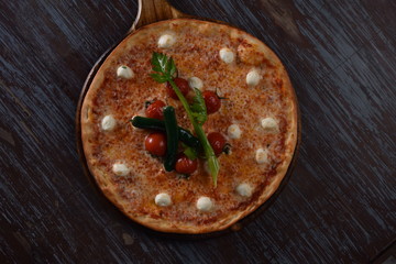 fresh pizza with tomatoes on the table