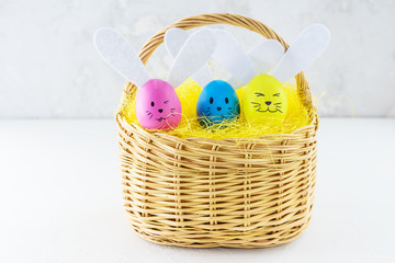 Easter bunnies of colored eggs in a wicker basket.