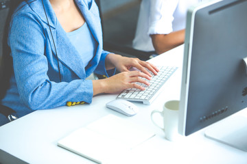 Fototapeta premium Business woman use computer for online shopping and typing on keyboard at Home office with white cup of coffee