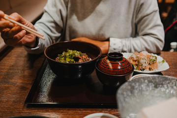 .European tourist eating Asian food in Tokyo, Japan. Trying new flavors during her trip. Close up. Lifestyle