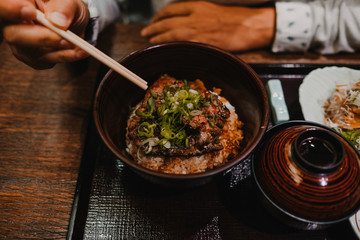 .European tourist eating Asian food in Tokyo, Japan. Trying new flavors during her trip. Close up. Lifestyle