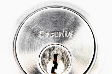 Security text on the door lock with key hole and white background. Safety concept.