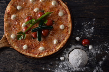 fresh pizza with tomatoes on the table