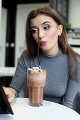 Smiling Woman with Coffee Frappe Drink at the Restaurant - Portrait of a beautiful girl with glass of frappuccino