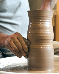 Working process of loam item in workshop. Man working in home studio. Craftsman at work.